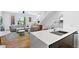 Open-concept kitchen, dining, and living space featuring modern finishes and lots of natural light at 2150 S Delaware St, Denver, CO 80223