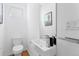Contemporary powder room with modern fixtures, a wall-mounted sink, and a clean design at 2150 S Delaware St, Denver, CO 80223