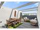 Enjoy outdoor living on this rooftop patio with dining and seating areas under a pergola at 2150 S Delaware St, Denver, CO 80223