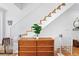 Bright staircase and open landing features wood stairs and white modern railing at 2150 S Delaware St, Denver, CO 80223