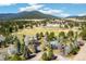 Aerial view of a property nestled among trees, with mountain views in the distance at 1927 Sunset Cir, Evergreen, CO 80439