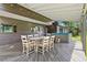 Covered back deck featuring a dining table and chairs, alongside a relaxing hot tub at 1927 Sunset Cir, Evergreen, CO 80439
