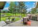 Serene backyard with a deck, outdoor kitchen, and lush greenery, perfect for entertaining at 1927 Sunset Cir, Evergreen, CO 80439