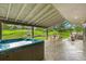 Spacious backyard view from the covered deck, showcasing the hot tub and outdoor dining area at 1927 Sunset Cir, Evergreen, CO 80439