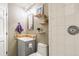 Modern bathroom with tiled shower, gray vanity and shelves; clean and functional design at 1927 Sunset Cir, Evergreen, CO 80439