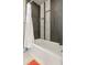 Modern bathroom featuring a stylish tub with sleek gray tiles and built-in shelving at 1927 Sunset Cir, Evergreen, CO 80439