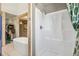 Bright bathroom featuring a modern bathtub and shower, accented by wood trim and light fixtures for a rustic touch at 1927 Sunset Cir, Evergreen, CO 80439