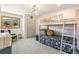 Charming bedroom with a bunk bed, a cozy chair, and a serene mountain view from the window, perfect for children at 1927 Sunset Cir, Evergreen, CO 80439
