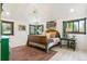Cozy bedroom with wood-framed windows, a patterned rug, and a vintage-inspired aesthetic, creating a tranquil retreat at 1927 Sunset Cir, Evergreen, CO 80439