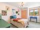 Inviting bedroom with a comfortable bed, colorful artwork, and a bright window offering a pleasant view, creating a cheerful space at 1927 Sunset Cir, Evergreen, CO 80439