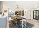 Open dining area with wood floors, gray cabinets, and a view into the living room at 1927 Sunset Cir, Evergreen, CO 80439