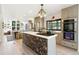 Stylish kitchen features a patterned kitchen island with gas range, custom gray cabinets and dining area at 1927 Sunset Cir, Evergreen, CO 80439