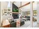 Sunlit living space features a fireplace, beamed ceilings and comfortable seating at 1927 Sunset Cir, Evergreen, CO 80439