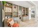Open living room with custom built-in gray shelving and cabinets, plus a colorful accent chair at 1927 Sunset Cir, Evergreen, CO 80439