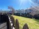 Fenced backyard area with green grass and townhome units behind it at 10561 W Dartmouth Ave, Lakewood, CO 80227