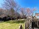 Exterior fenced backyard with grassy area and a view of neighboring townhomes at 10561 W Dartmouth Ave, Lakewood, CO 80227