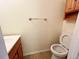 Bathroom with wooden vanity, toilet, and mounted cabinet at 10561 W Dartmouth Ave, Lakewood, CO 80227
