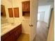 Bright bathroom features double sinks, cabinet storage, and a full-sized mirror at 10561 W Dartmouth Ave, Lakewood, CO 80227