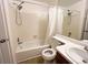 Bathroom with shower and tub combination next to a sink and toilet at 10561 W Dartmouth Ave, Lakewood, CO 80227