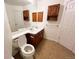 Bathroom with double sinks, white countertops, and wood cabinets at 10561 W Dartmouth Ave, Lakewood, CO 80227