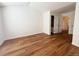 Bedroom featuring hardwood floors, white walls, and a closet at 10561 W Dartmouth Ave, Lakewood, CO 80227