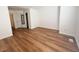 Bedroom featuring hardwood floors, white walls, and access to multiple rooms at 10561 W Dartmouth Ave, Lakewood, CO 80227