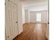 Bedroom featuring hardwood floors, white walls, and a window for natural light at 10561 W Dartmouth Ave, Lakewood, CO 80227