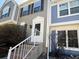 Inviting townhouse with a charming front door and well-maintained landscaping at 10561 W Dartmouth Ave, Lakewood, CO 80227