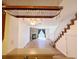 Open floor plan flows from kitchen into living room with stone fireplace and stairs at 10561 W Dartmouth Ave, Lakewood, CO 80227