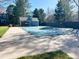 Community pool with large concrete surround and covered for the off-season at 10561 W Dartmouth Ave, Lakewood, CO 80227