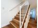 Staircase with wood steps and white railing leading to the next level at 10561 W Dartmouth Ave, Lakewood, CO 80227