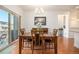 Dining room featuring sliding glass doors, hardwood floors, and contemporary lighting at 11791 Barrentine Loop, Parker, CO 80138