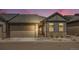 Charming single-Gathering home with a well-manicured front yard and a two-car garage, set against a colorful sunset at 11791 Barrentine Loop, Parker, CO 80138