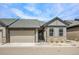 Charming home featuring stone accents, a well-kept lawn, and an attached two-car garage at 11791 Barrentine Loop, Parker, CO 80138