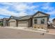 Charming home featuring stone accents, a well-kept lawn, and attached two-car garages at 11791 Barrentine Loop, Parker, CO 80138