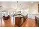 Bright open kitchen boasts a large island with granite countertops and stainless steel appliances at 11791 Barrentine Loop, Parker, CO 80138