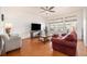 Cozy living room featuring three windows, hardwood floors, and comfortable seating arrangements at 11791 Barrentine Loop, Parker, CO 80138