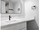 Modern bathroom with sleek black fixtures, bright white countertops, and a large mirror at 6519 Pinewood Dr, Parker, CO 80134