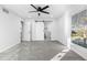 Bright bedroom with a ceiling fan, large window, and sliding barn door leading to the en-suite bathroom at 6519 Pinewood Dr, Parker, CO 80134