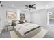 Bright bedroom features a king bed, large windows, and a ceiling fan at 6519 Pinewood Dr, Parker, CO 80134