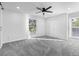 Spacious bedroom featuring a ceiling fan, large windows, and plush carpeting at 6519 Pinewood Dr, Parker, CO 80134
