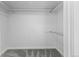 This is a roomy walk-in closet with a closet rod and gray carpeting at 6519 Pinewood Dr, Parker, CO 80134