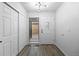 Entryway with hardwood floors, a closet, and a decorative front door with sidelight at 6519 Pinewood Dr, Parker, CO 80134