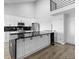 Modern kitchen featuring white cabinets, black hardware and marble countertops, with a loft view at 6519 Pinewood Dr, Parker, CO 80134