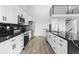 Modern kitchen features white cabinets, stainless steel appliances, and a black marbled countertop at 6519 Pinewood Dr, Parker, CO 80134