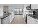 Kitchen featuring white cabinets, stainless steel appliances, and black marble countertops with a patio view at 6519 Pinewood Dr, Parker, CO 80134