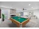 Open living room with pool table, fireplace, and modern furniture at 6519 Pinewood Dr, Parker, CO 80134