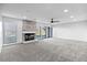 Large living room with stone fireplace and sliding glass doors for natural light at 6519 Pinewood Dr, Parker, CO 80134