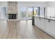 Open living room featuring a fireplace, kitchen with marble countertops, and a balcony view at 6519 Pinewood Dr, Parker, CO 80134