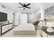 A main bedroom offers a sliding barn door leading to the en suite bathroom and a ceiling fan at 6519 Pinewood Dr, Parker, CO 80134